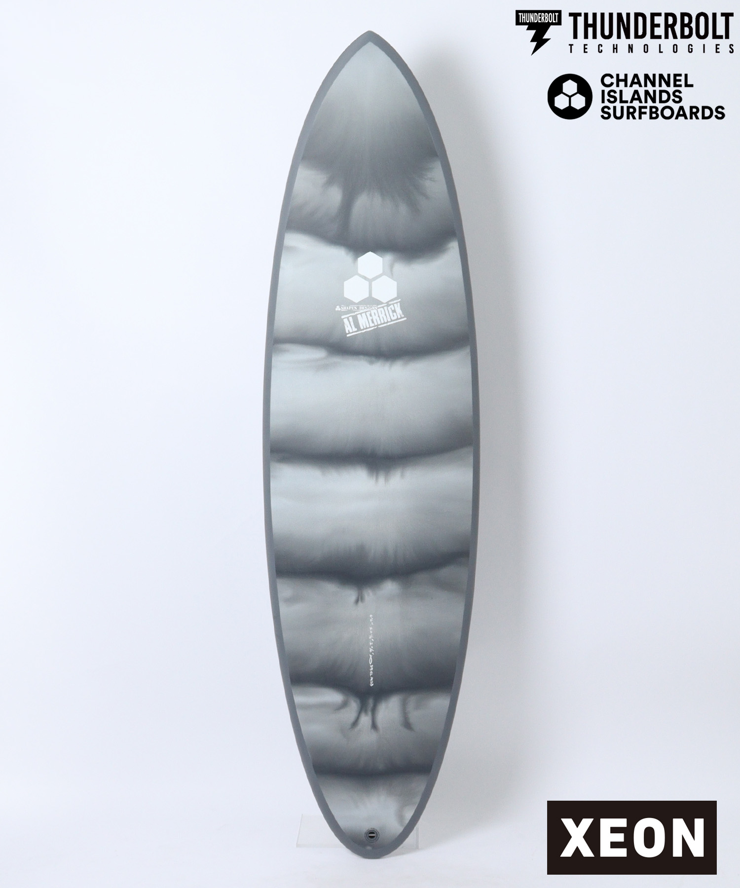 Grey surfboard fin with a white hex logo and 'AL MERRICK' text; Thunderbolt Technologies and Channel Islands Surfboards logos in the top-right, plus a black XEON label in the bottom-right.