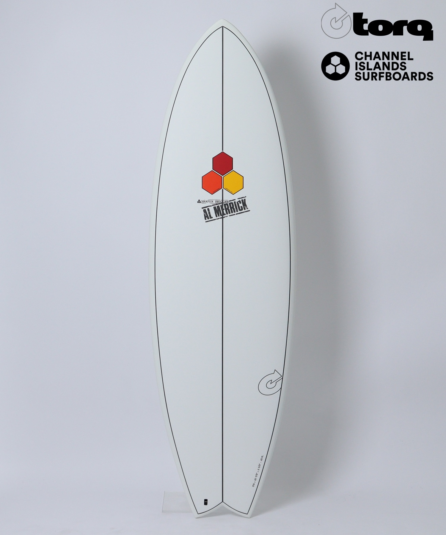 image - SHOP NEWS | ムラサキスポーツオンラインストア 通販 White surfboard standing upright on a light background, with Torq and Channel Islands logos at the top-right and a three-hexagon emblem with 'AL MERRICK' on the board's center.