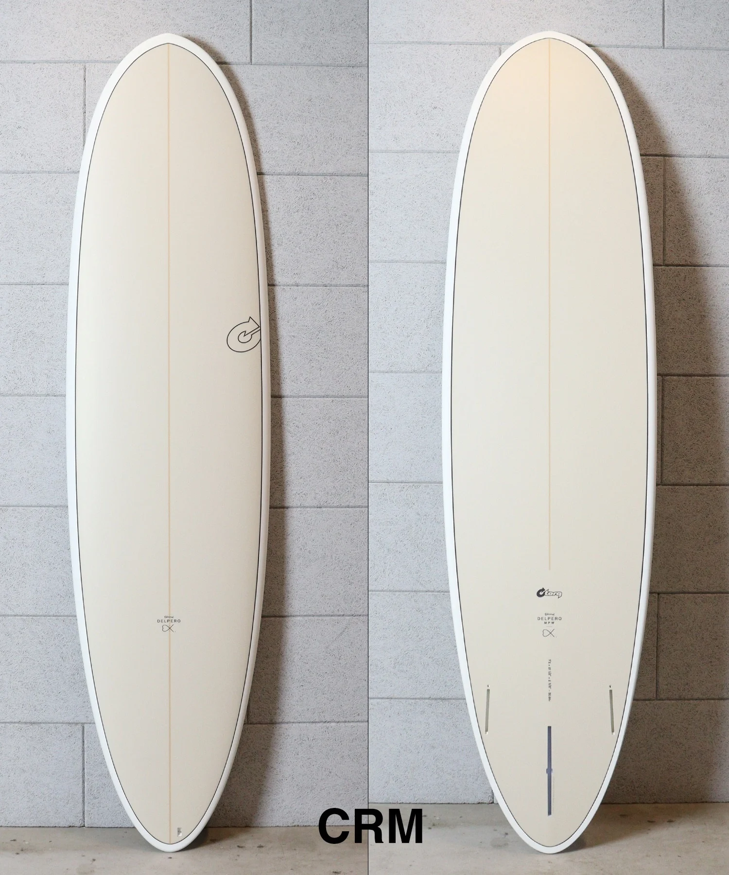 image - SHOP NEWS | ムラサキスポーツオンラインストア 通販 Two cream surfboards standing upright side by side against a tiled wall, each with subtle branding near the bottom (left board shows a circular logo).